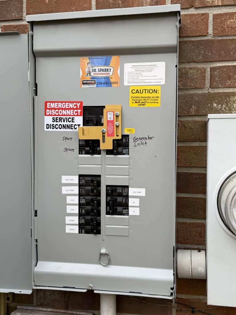 Residential generator service panel with safety labels and disconnect switch.
