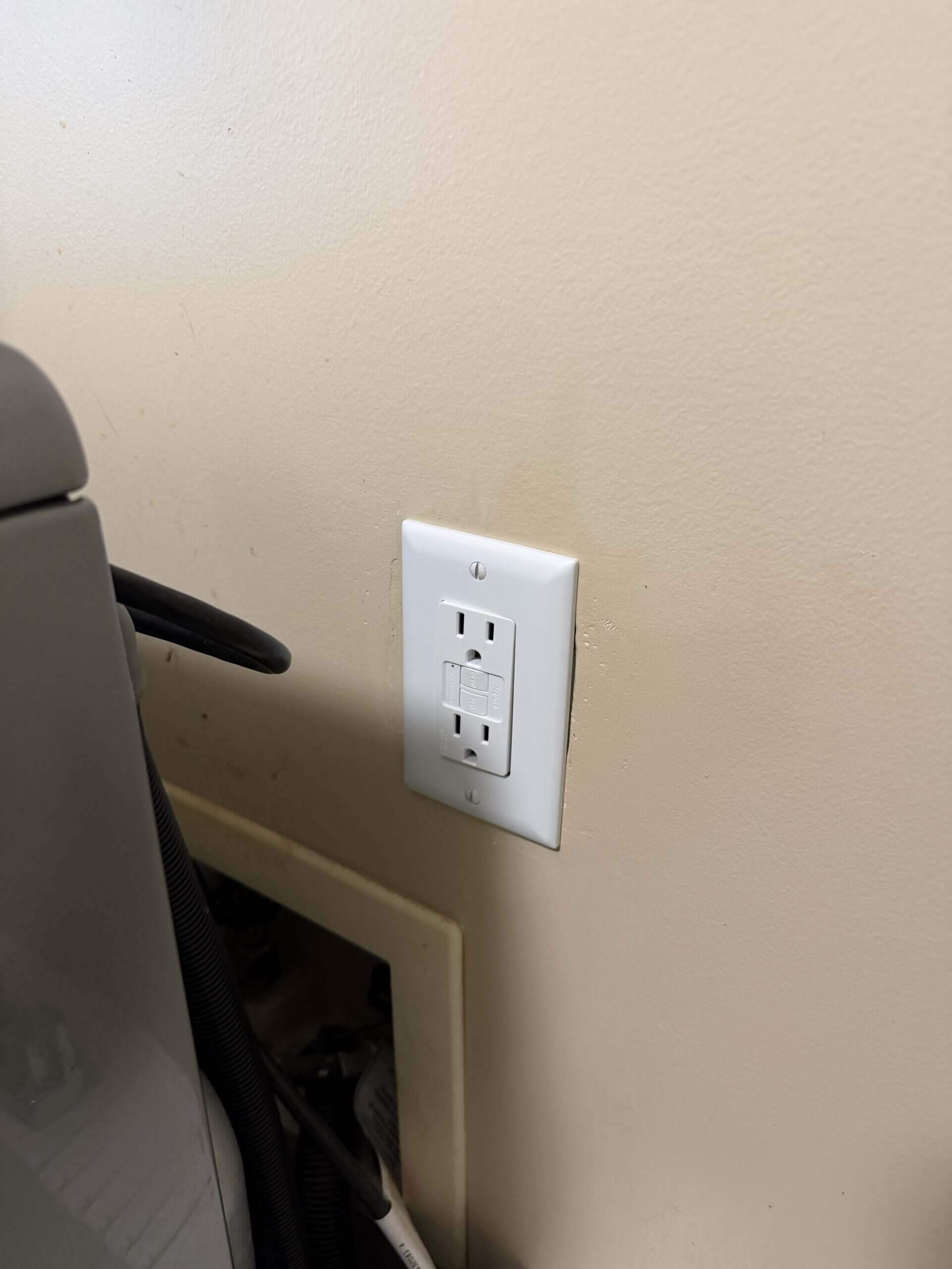 Electrical outlet with a grounded socket for safe power connection.